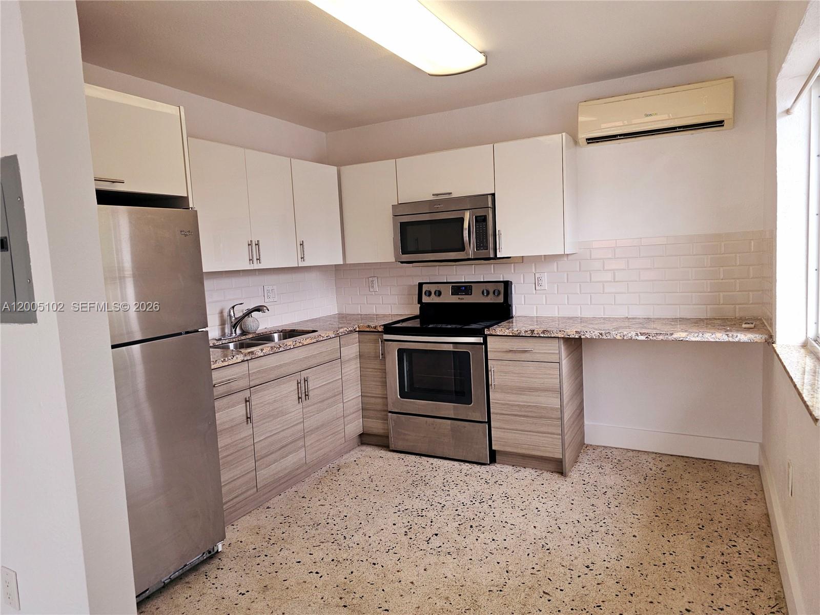 1736 Southwest 3rd Street, Unit 3 Miami, FL 33135 - Photo 5 of 10 a kitchen with white cabinets and white appliances
