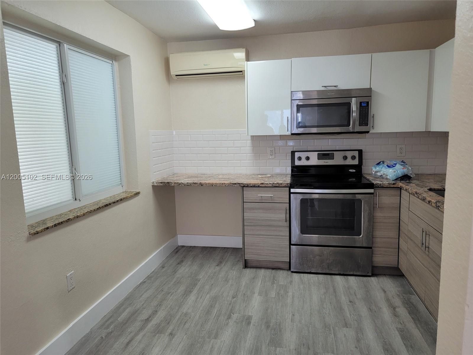 1736 Southwest 3rd Street, Unit 3 Miami, FL 33135 - Photo 9 of 10 a kitchen with a stove and a microwave