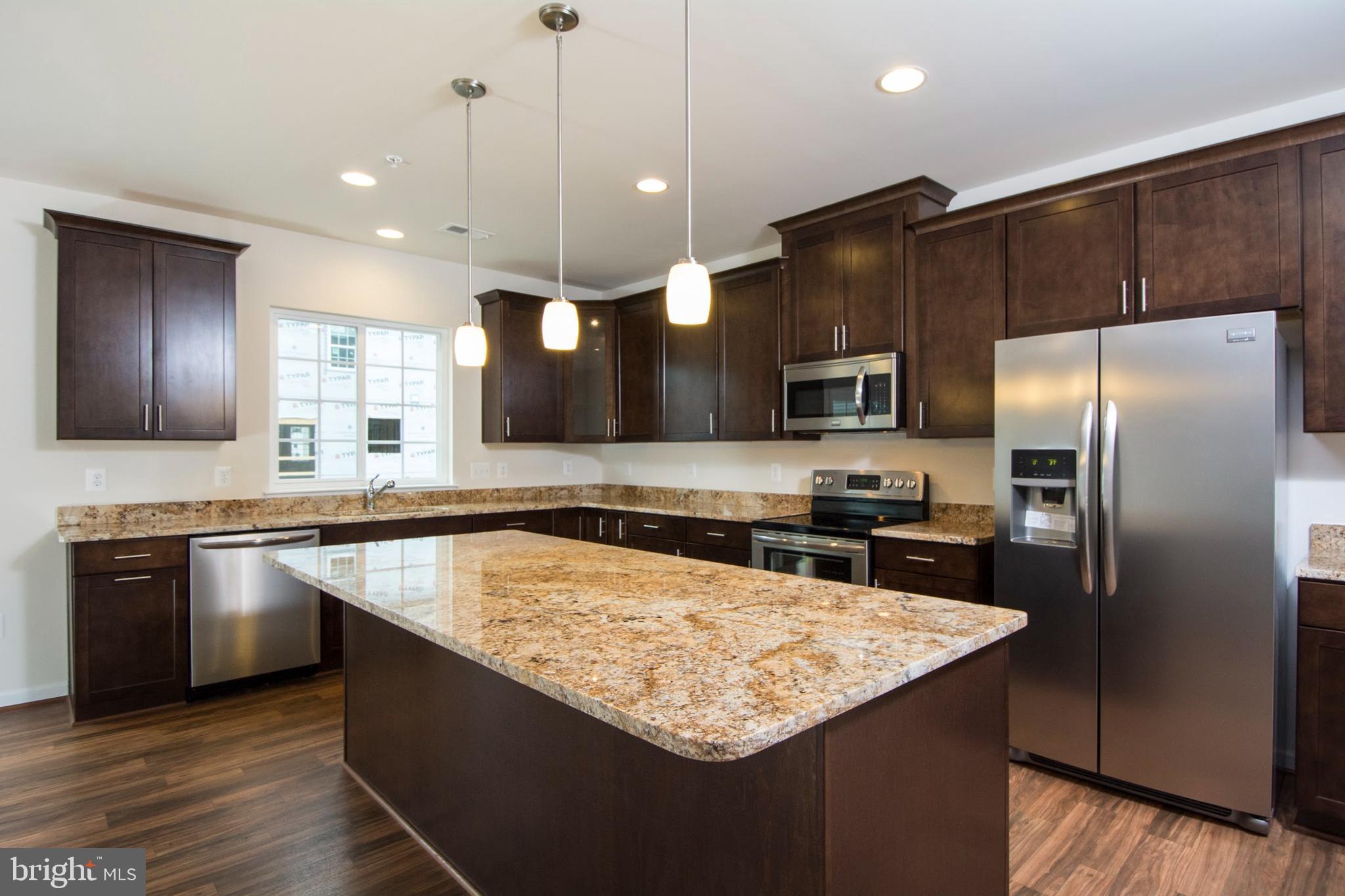 14894 Mason Creek Circle Woodbridge, VA 22191 - Photo 3 of 25 a kitchen with stainless steel appliances granite countertop a sink a stove and a refrigerator