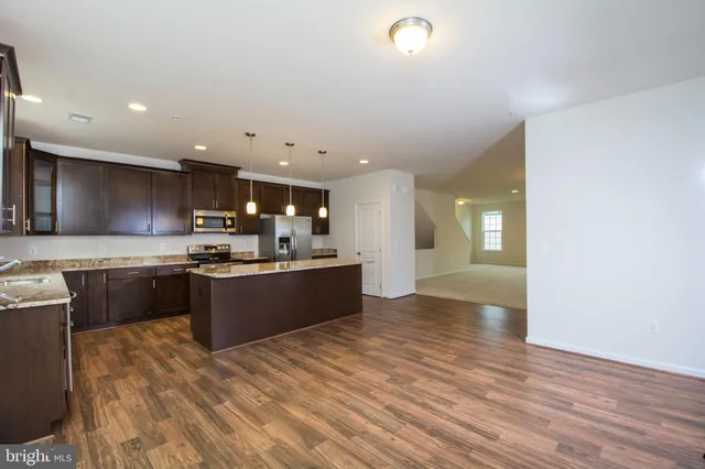 a large kitchen with a large counter top appliances and cabinets