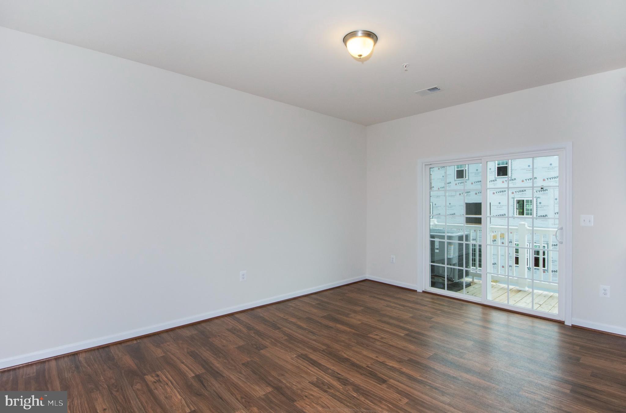 14894 Mason Creek Circle Woodbridge, VA 22191 - Photo 5 of 25 an empty room with wooden floor
