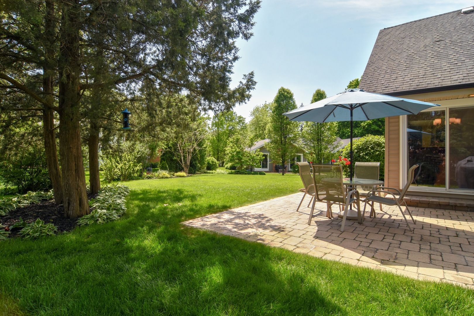 4 Burning Tree Road Rolling Meadows, IL 60008 - Photo 29 of 31 a view of a table and chairs under an umbrella