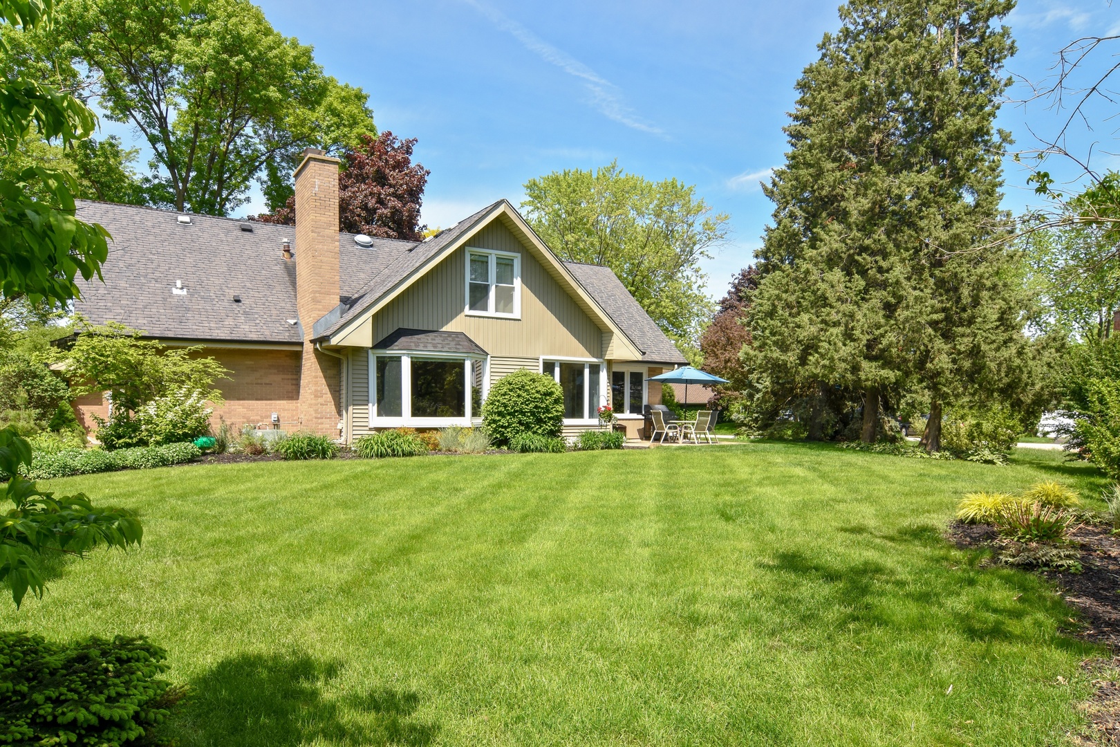 4 Burning Tree Road Rolling Meadows, IL 60008 - Photo 30 of 31 a front view of a house with a yard and trees