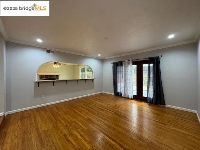 a view of a room with wooden floor