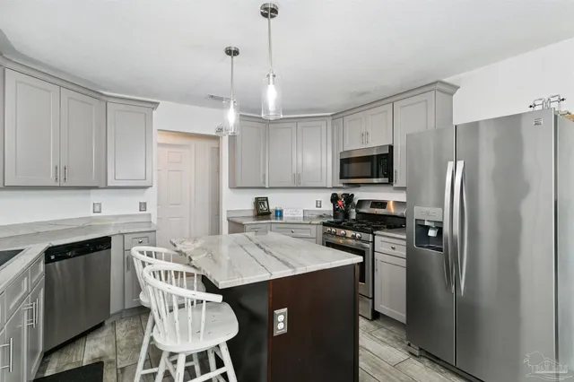 a kitchen with a sink a stove a refrigerator and cabinets
