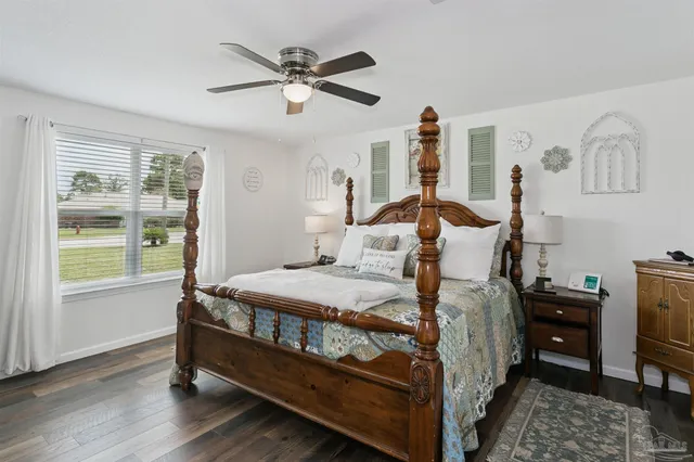 a bedroom with a bed and a flat tv screen on dresser