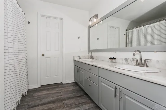 a bedroom with bed and a chandelier