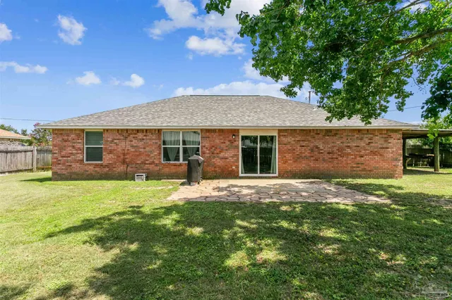 a front view of a house with a garden and yard