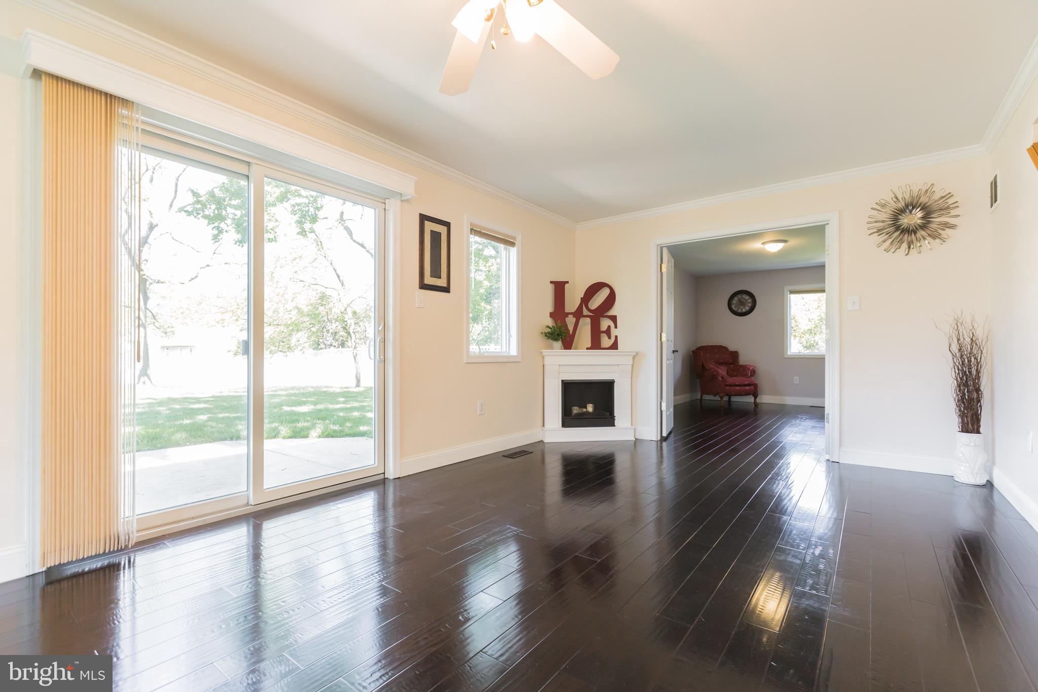 525 Coles Mill Road Haddonfield, NJ 08033 - Photo 14 of 36 a view of a living room and a large window with wooden floor