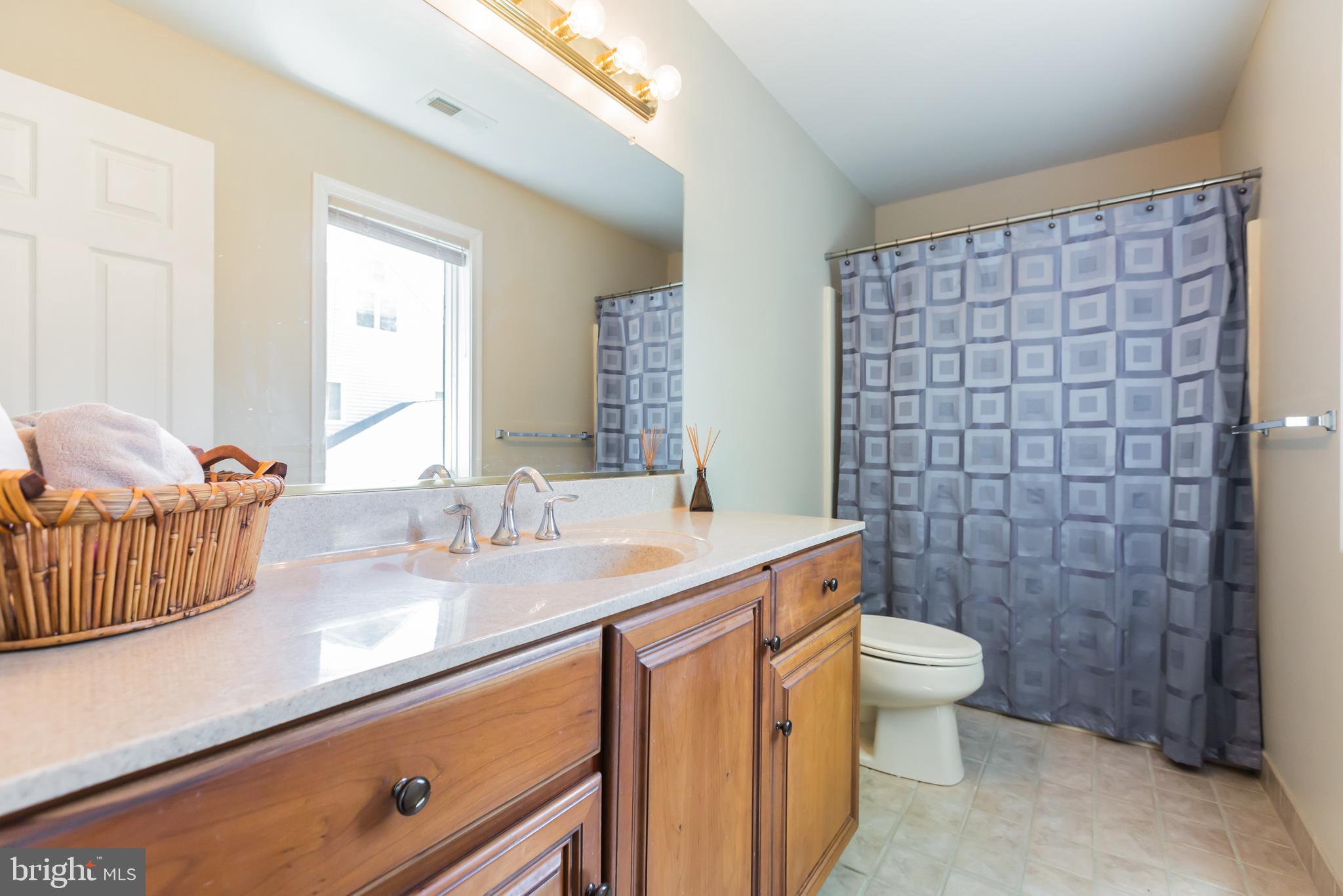 525 Coles Mill Road Haddonfield, NJ 08033 - Photo 24 of 36 a bathroom with a granite countertop sink a toilet and a mirror
