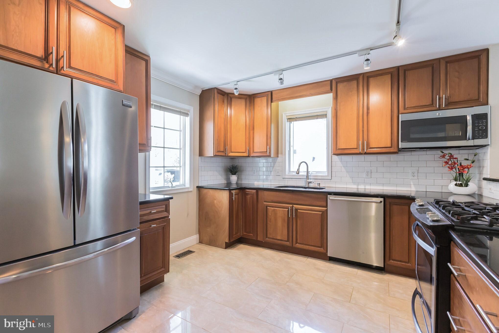 525 Coles Mill Road Haddonfield, NJ 08033 - Photo 4 of 36 a kitchen with stainless steel appliances granite countertop a refrigerator stove top oven a sink and dishwasher