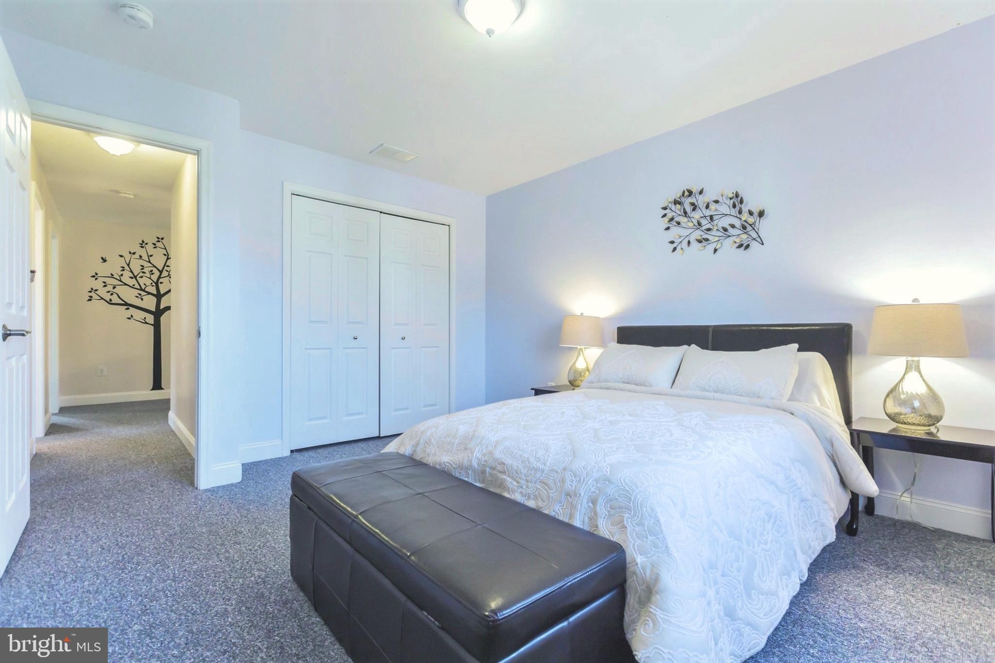 525 Coles Mill Road Haddonfield, NJ 08033 - Photo 31 of 36 a bedroom with a bed and a table in it