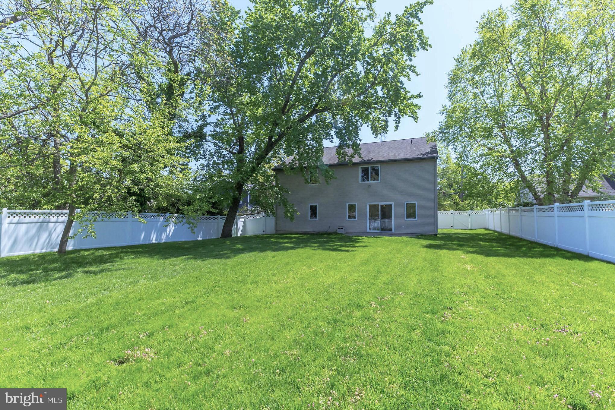 525 Coles Mill Road Haddonfield, NJ 08033 - Photo 36 of 36 a backyard of a house with lots of plants and large tree