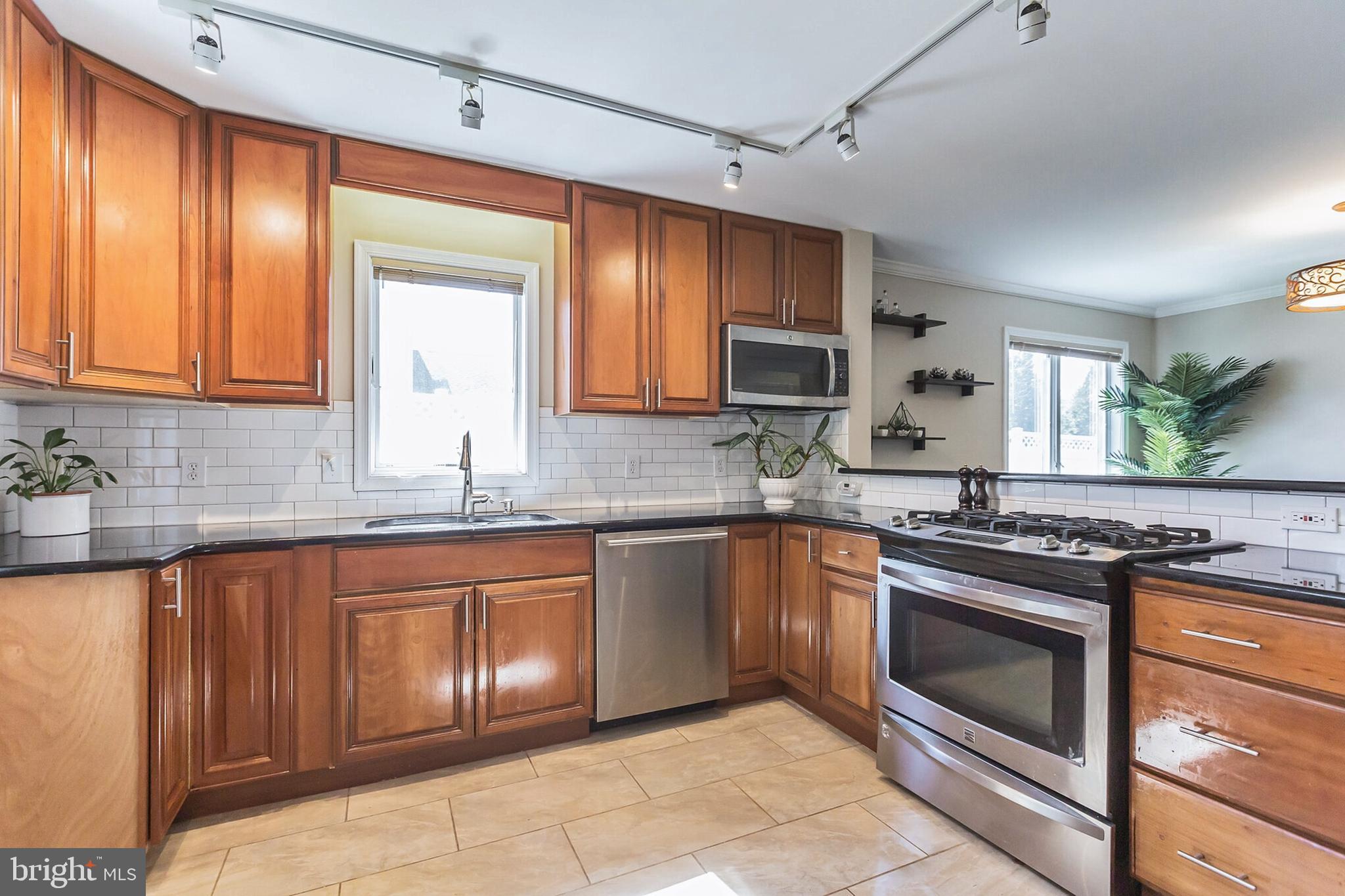 525 Coles Mill Road Haddonfield, NJ 08033 - Photo 5 of 36 a kitchen with granite countertop stainless steel appliances stove sink and cabinets