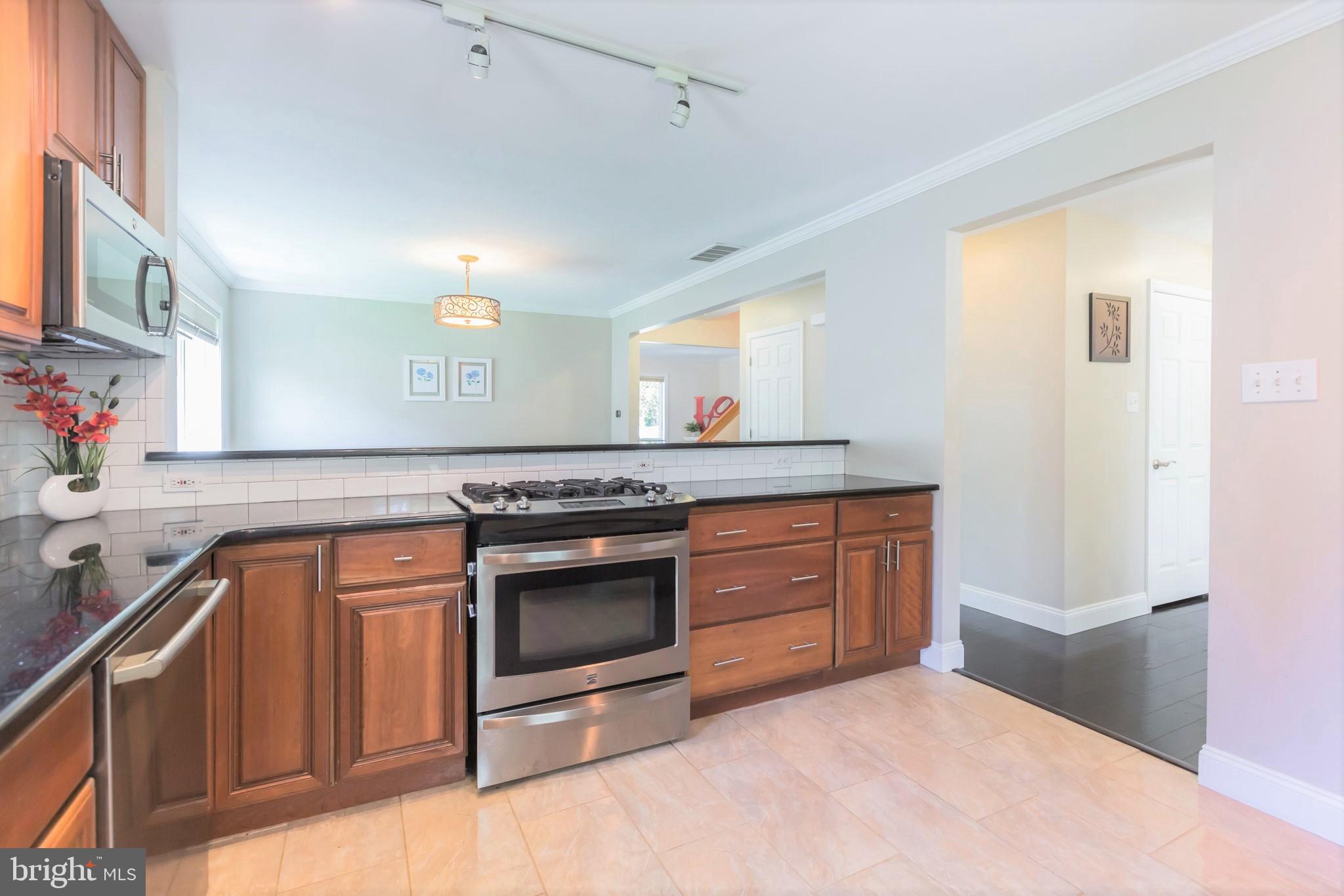 525 Coles Mill Road Haddonfield, NJ 08033 - Photo 6 of 36 a kitchen with stainless steel appliances granite countertop a sink and a stove