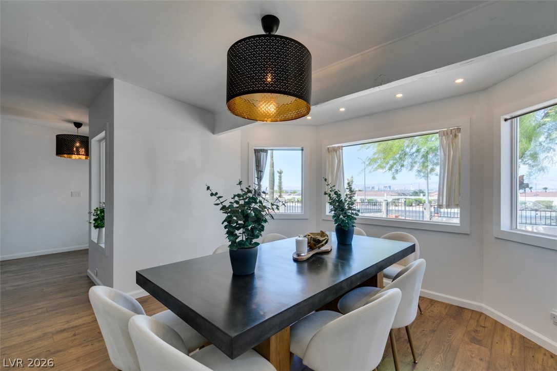 892 North Hollywood Boulevard Las Vegas, NV 89110 - Photo 1 of 81 This dining area boasts panoramic views, recessed lighting, and elegant wood flooring, creating an inviting space for gatherings.