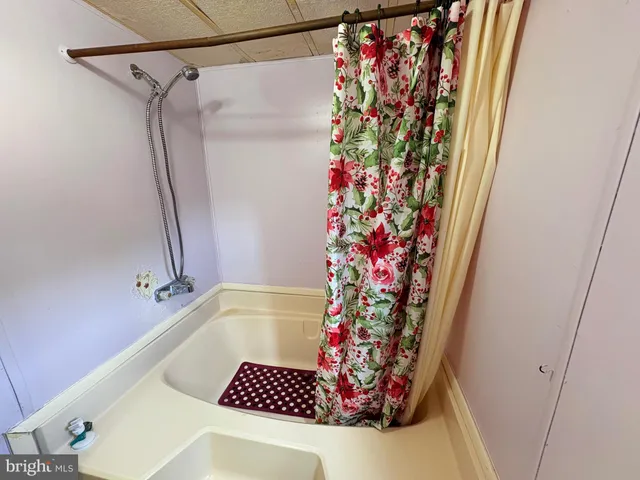 a bathroom with a shower and a sink