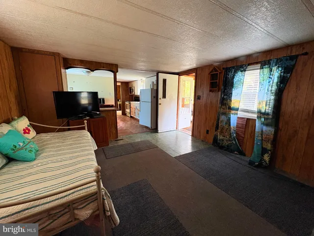 a bed room with a bed and a television