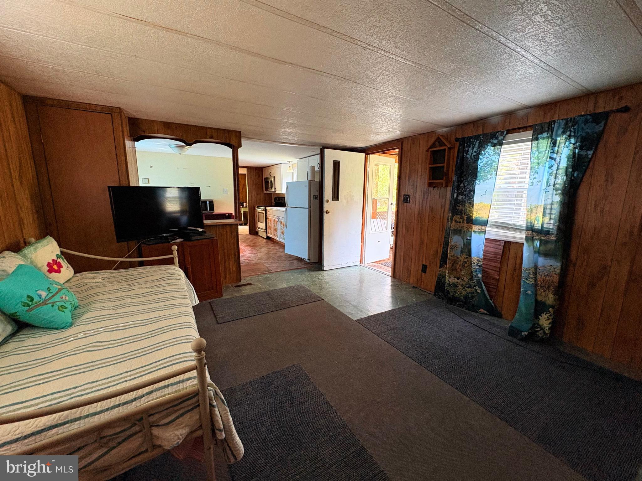 27199 Nevitte Muir Road Westover, MD 21871 - Photo 12 of 31 a bed room with a bed and a television