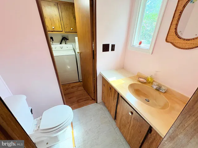 a bathroom with a sink a toilet and a mirror