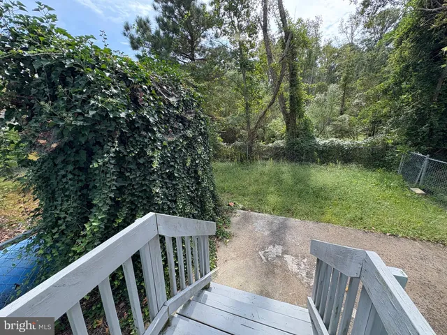 a balcony with wooden floor and lake view