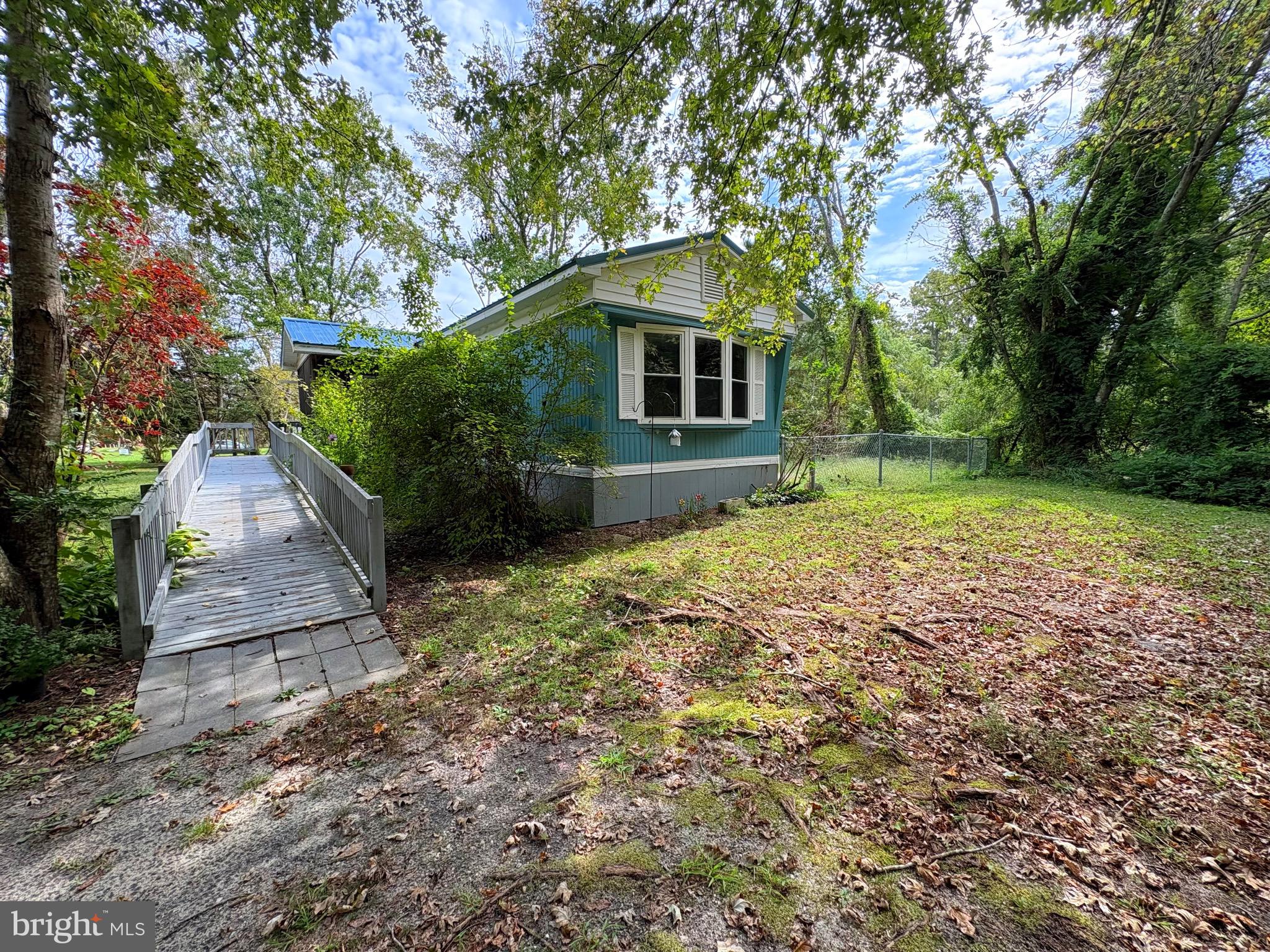 27199 Nevitte Muir Road Westover, MD 21871 - Photo 28 of 31 a backyard of a house with large trees and wooden fence