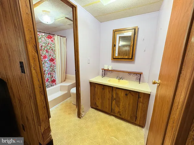 a bathroom with a tub sink and mirror