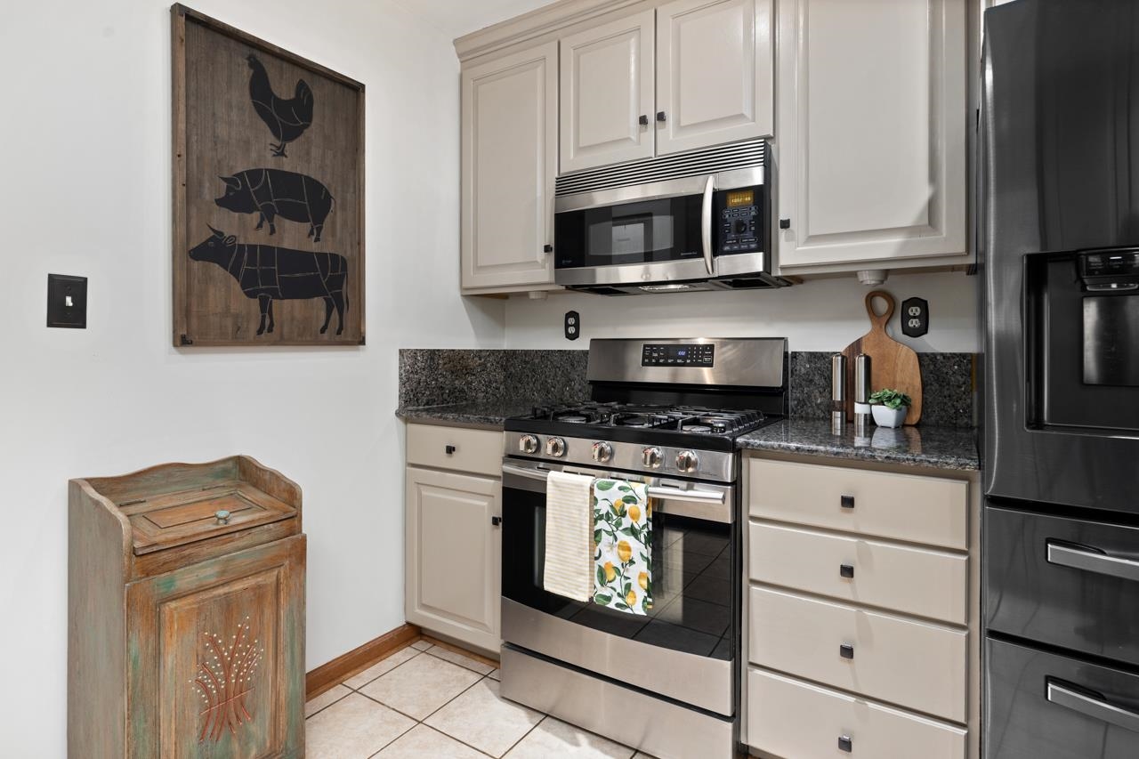 2151 Stagebridge Road Lovingston, VA 22949 - Photo 15 of 51 a kitchen with stainless steel appliances granite countertop white cabinets stove top oven and sink
