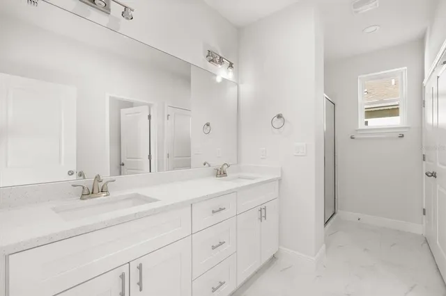 a bathroom with double sink and a mirror