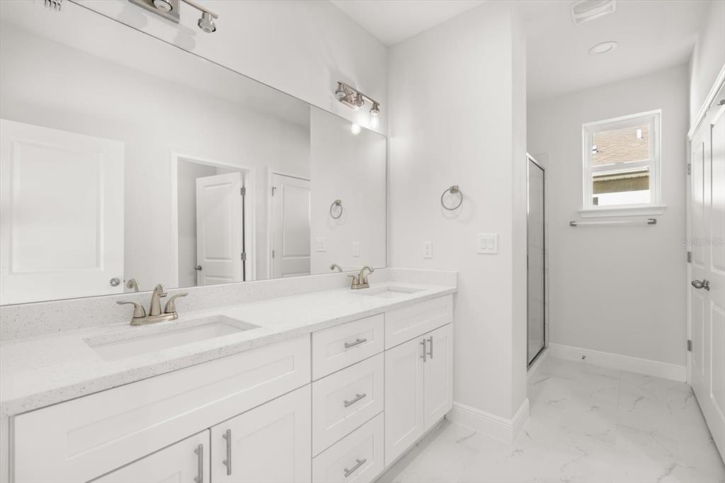 1289 Ash Tree Cove Casselberry, FL 32707 - Photo 18 of 34 a bathroom with double sink and a mirror