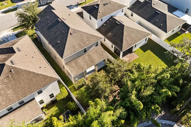 an aerial view of a house with a yard