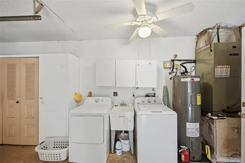 a view of walk in closet with clothes