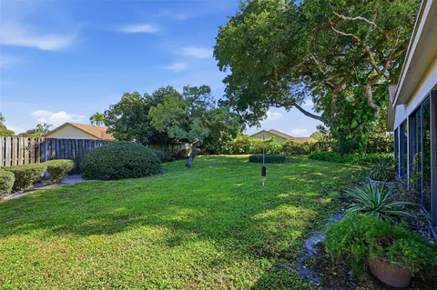 an aerial view of a house with yard swimming pool and outdoor seating