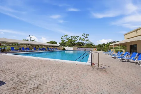 an aerial view of a house with yard swimming pool and outdoor seating