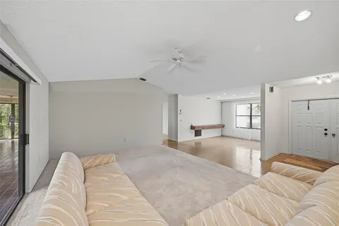 a large white kitchen with a large window and stainless steel appliances