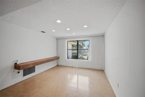 a large white kitchen with a large window appliances and furniture