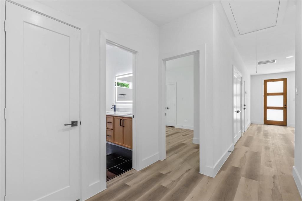 2714 Hector Street Dallas, TX 75210 - Photo 15 of 33 a view of a hallway with wooden floor and closet