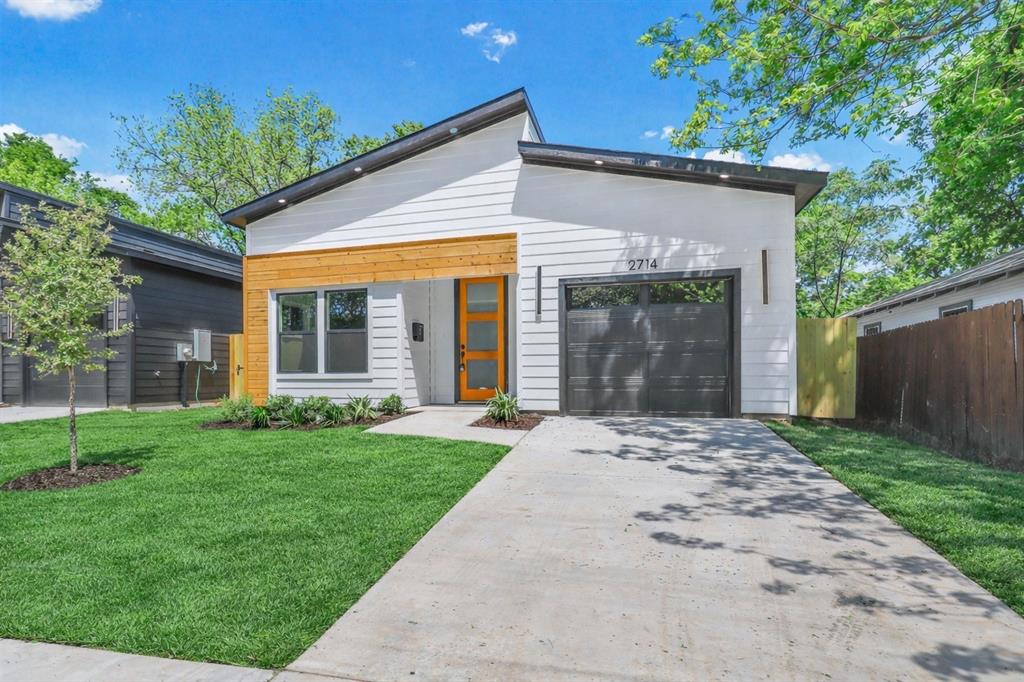 2714 Hector Street Dallas, TX 75210 - Photo 2 of 33 front view of a house with a yard and an trees