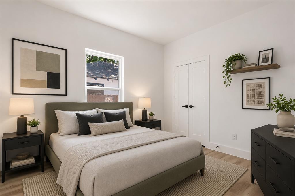 2714 Hector Street Dallas, TX 75210 - Photo 26 of 33 a bedroom with a bed and a flat tv screen on the dresser
