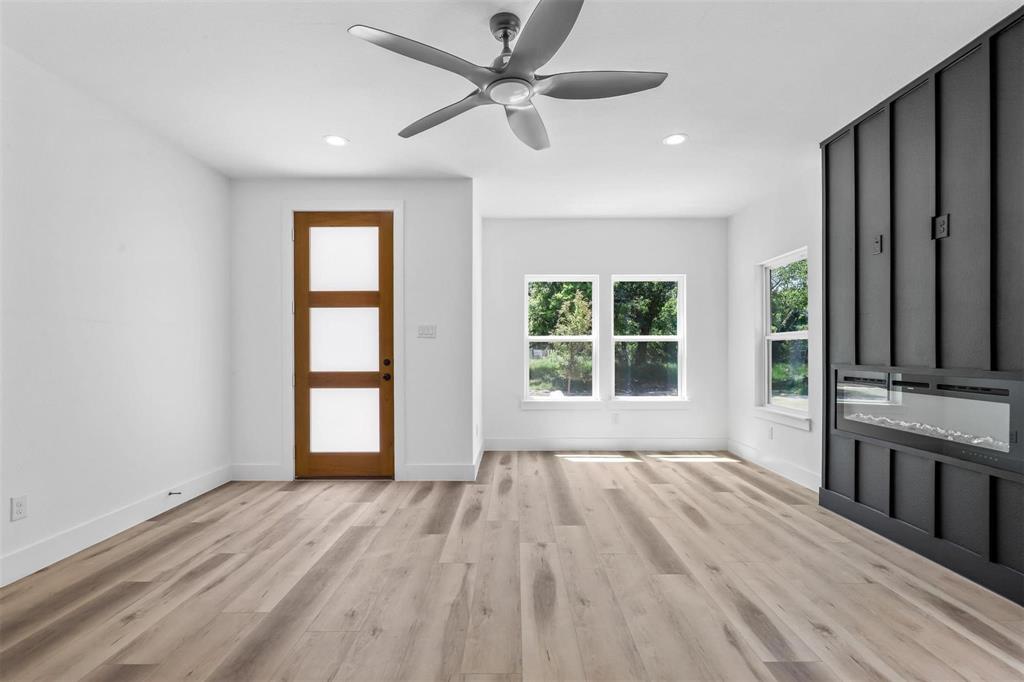 2714 Hector Street Dallas, TX 75210 - Photo 5 of 33 a view of an empty room with a window and wooden floor