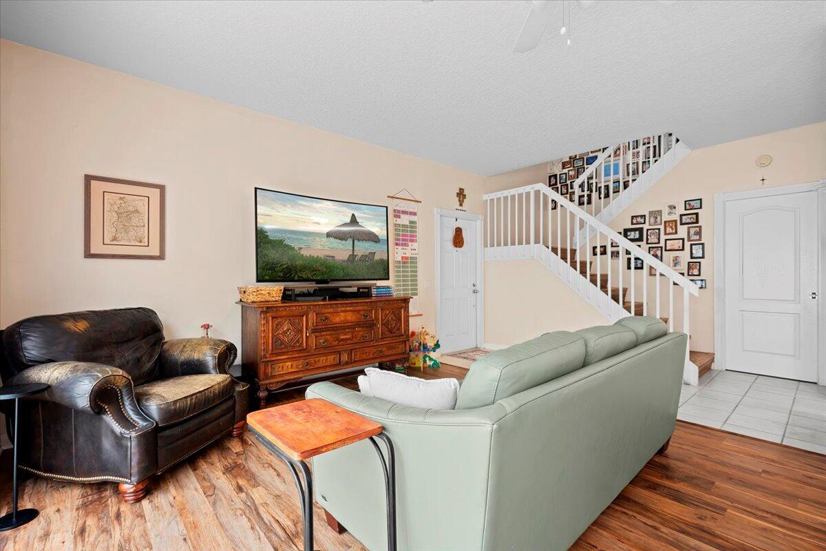 11 Live Oak Circle, Unit 11 Tequesta, FL 33469 - Photo 12 of 27 a living room with furniture and a flat screen tv