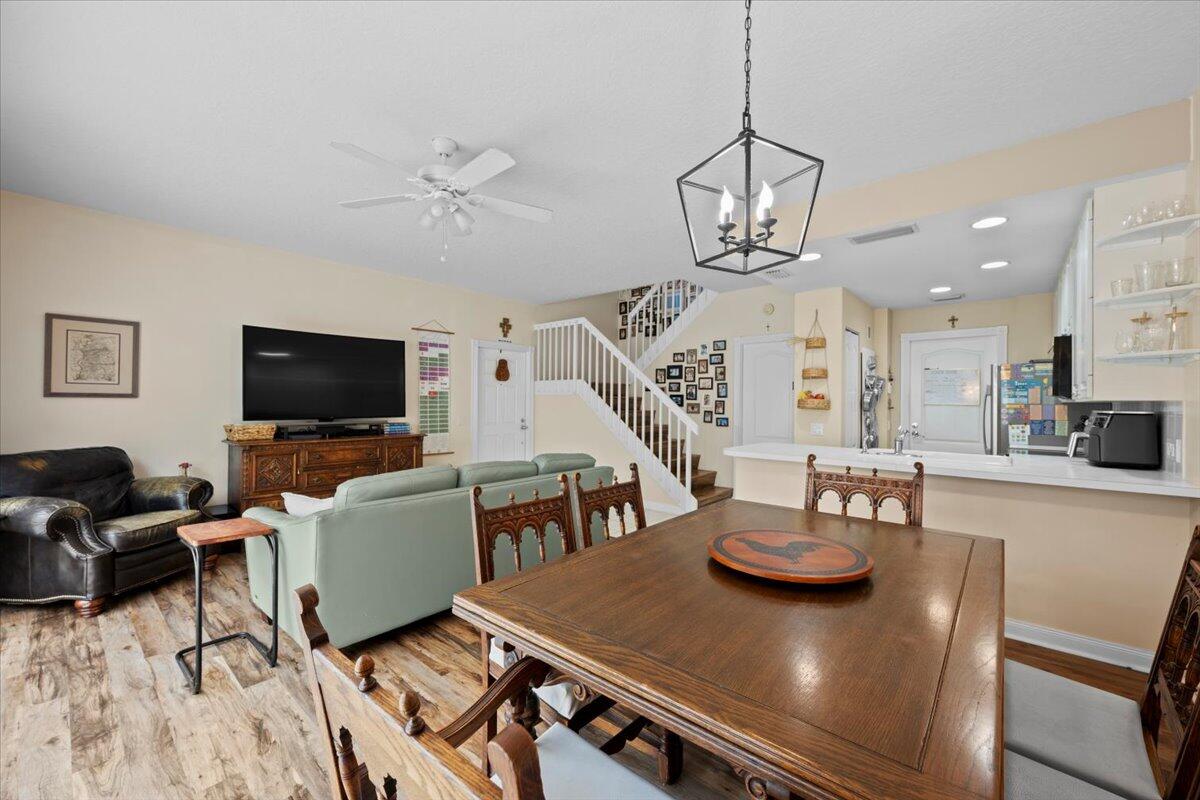 11 Live Oak Circle, Unit 11 Tequesta, FL 33469 - Photo 13 of 27 a view of a dining room with furniture a chandelier and wooden floor