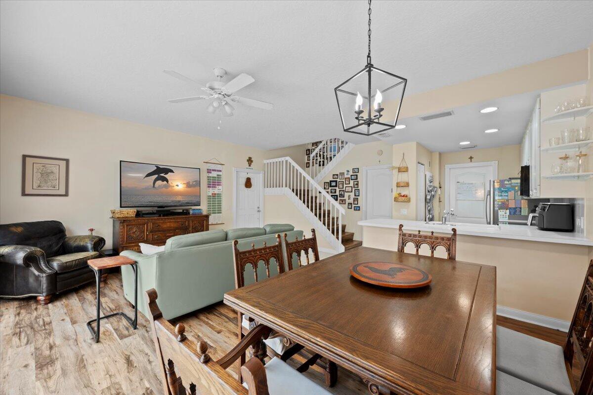 11 Live Oak Circle, Unit 11 Tequesta, FL 33469 - Photo 14 of 27 a view of a dining room with furniture a chandelier and wooden floor