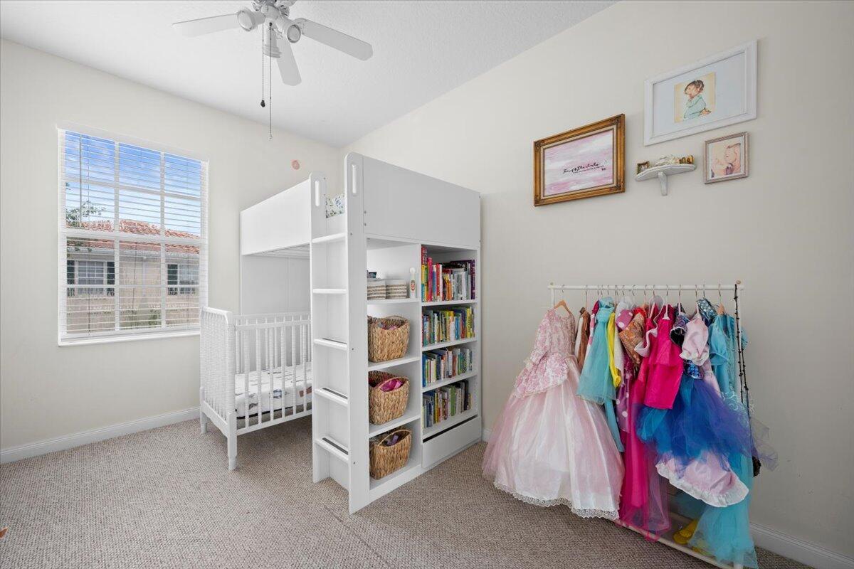 11 Live Oak Circle, Unit 11 Tequesta, FL 33469 - Photo 20 of 27 a living room with furniture and a book shelf