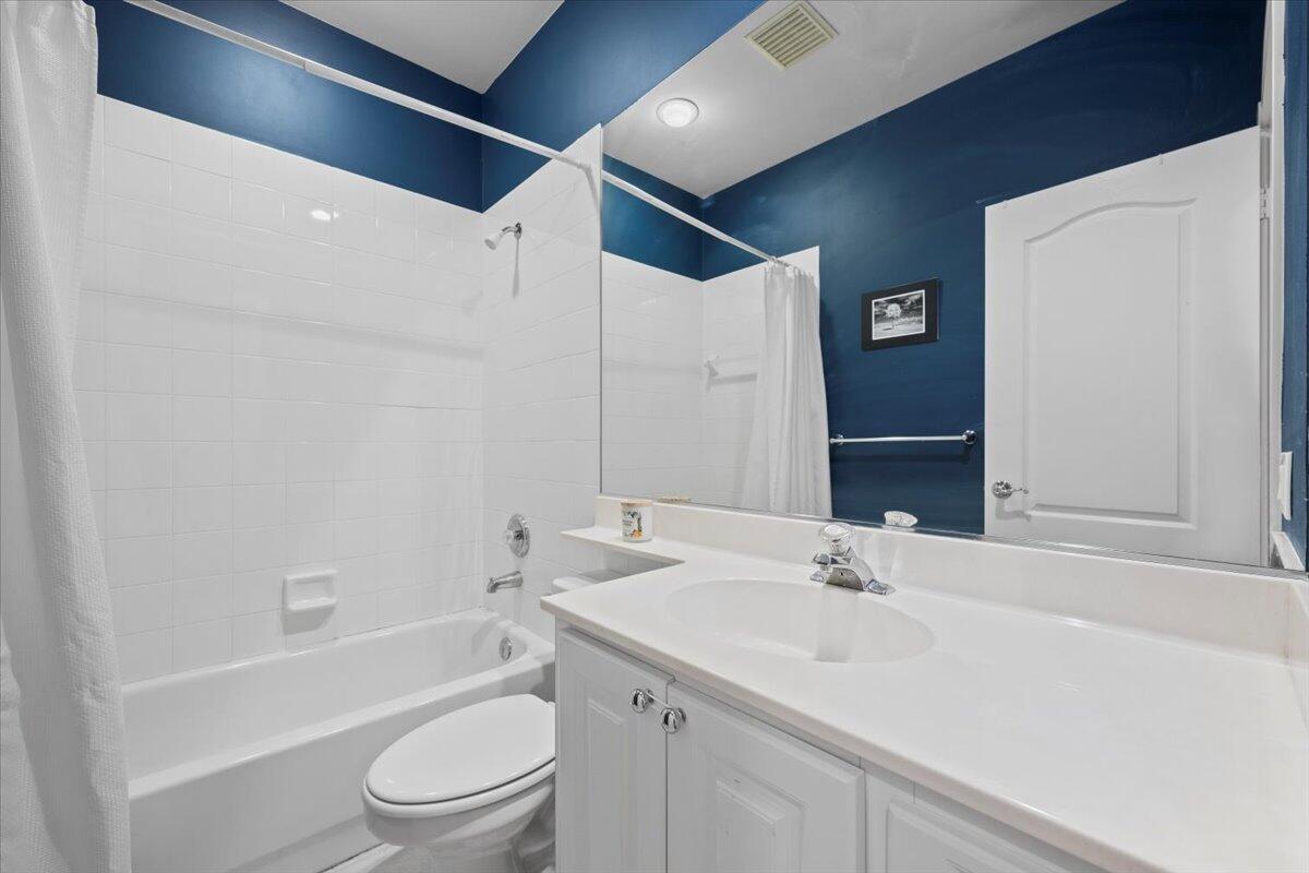 11 Live Oak Circle, Unit 11 Tequesta, FL 33469 - Photo 22 of 27 a bathroom with a sink a toilet and shower