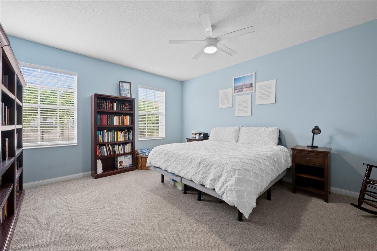11 Live Oak Circle, Unit 11 Tequesta, FL 33469 - Photo 24 of 27 a large bed sitting in a bedroom next to a window