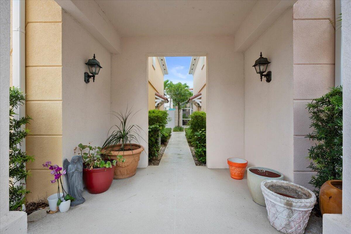 11 Live Oak Circle, Unit 11 Tequesta, FL 33469 - Photo 3 of 27 a vase of flowers sitting on a floor