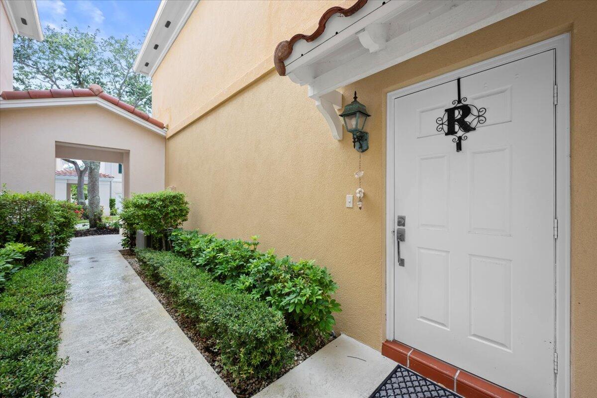 11 Live Oak Circle, Unit 11 Tequesta, FL 33469 - Photo 4 of 27 a front view of a house with garden