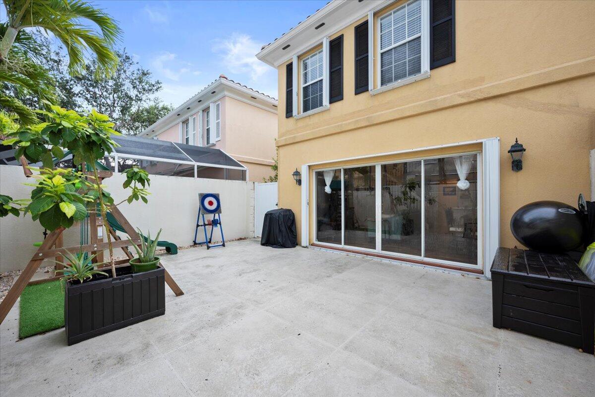 11 Live Oak Circle, Unit 11 Tequesta, FL 33469 - Photo 6 of 27 a view of a house with a barbeque and potted plants