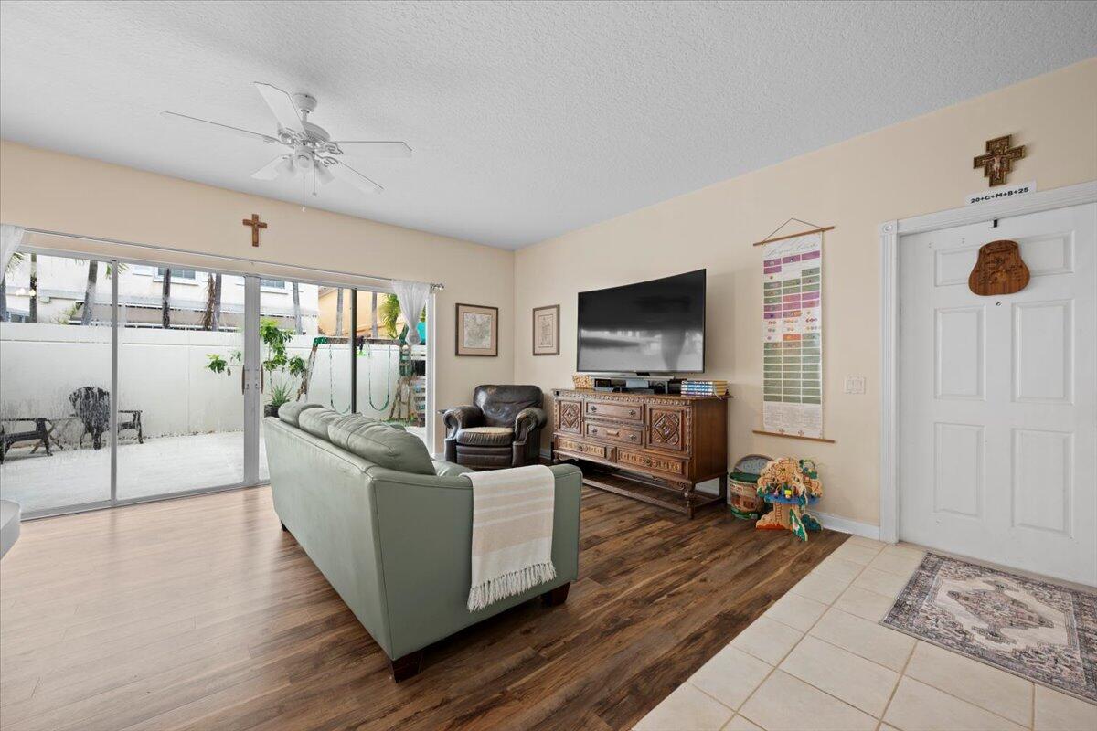 11 Live Oak Circle, Unit 11 Tequesta, FL 33469 - Photo 9 of 27 a living room with furniture and a flat screen tv
